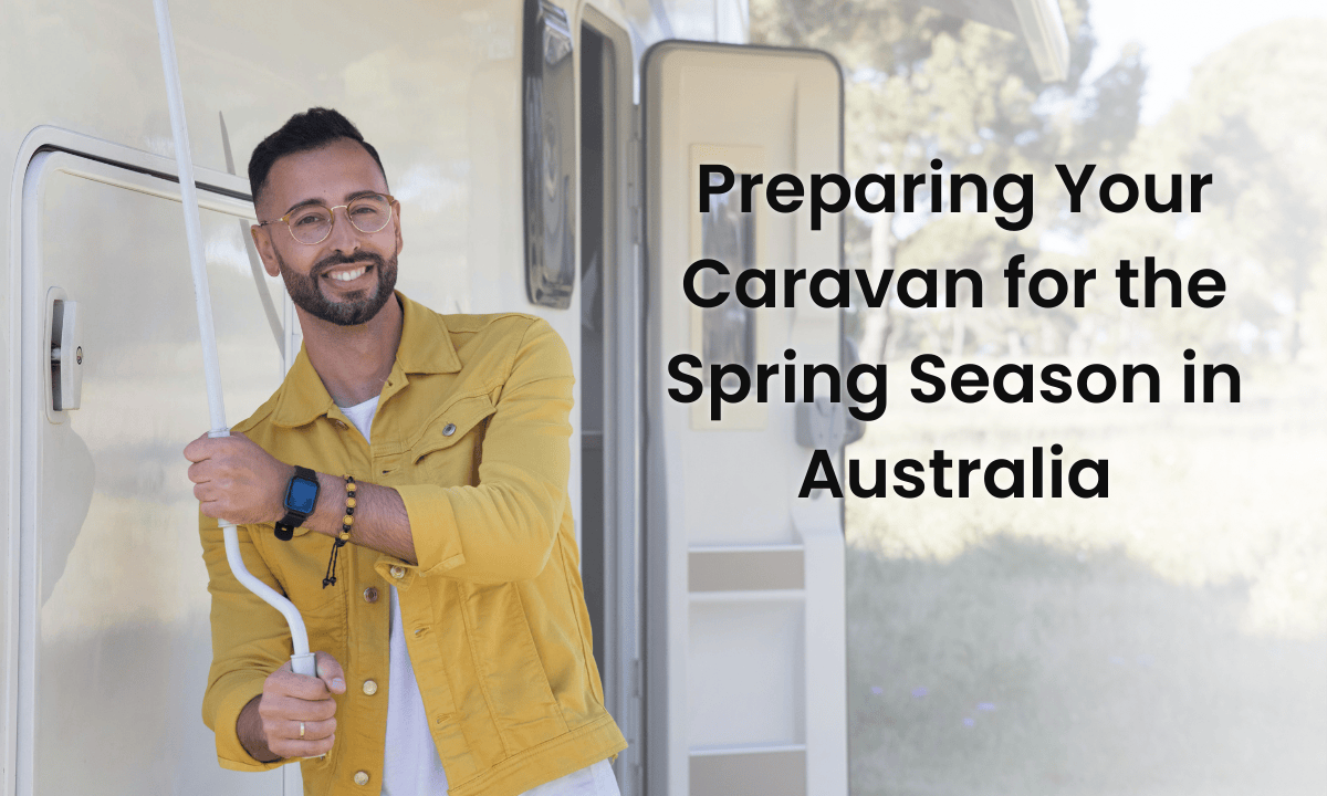 Caravan parked at a spring campsite surrounded by nature – preparing caravan for spring travel.