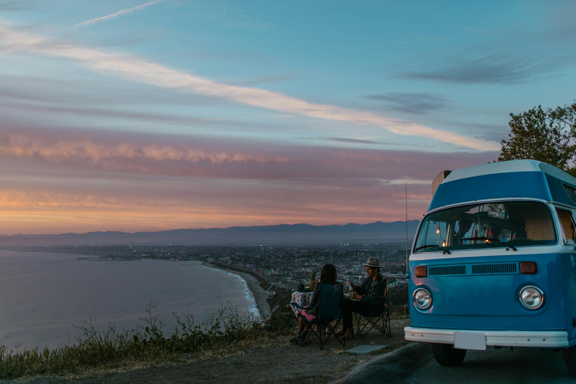 Couple camping with caravan on a road trip